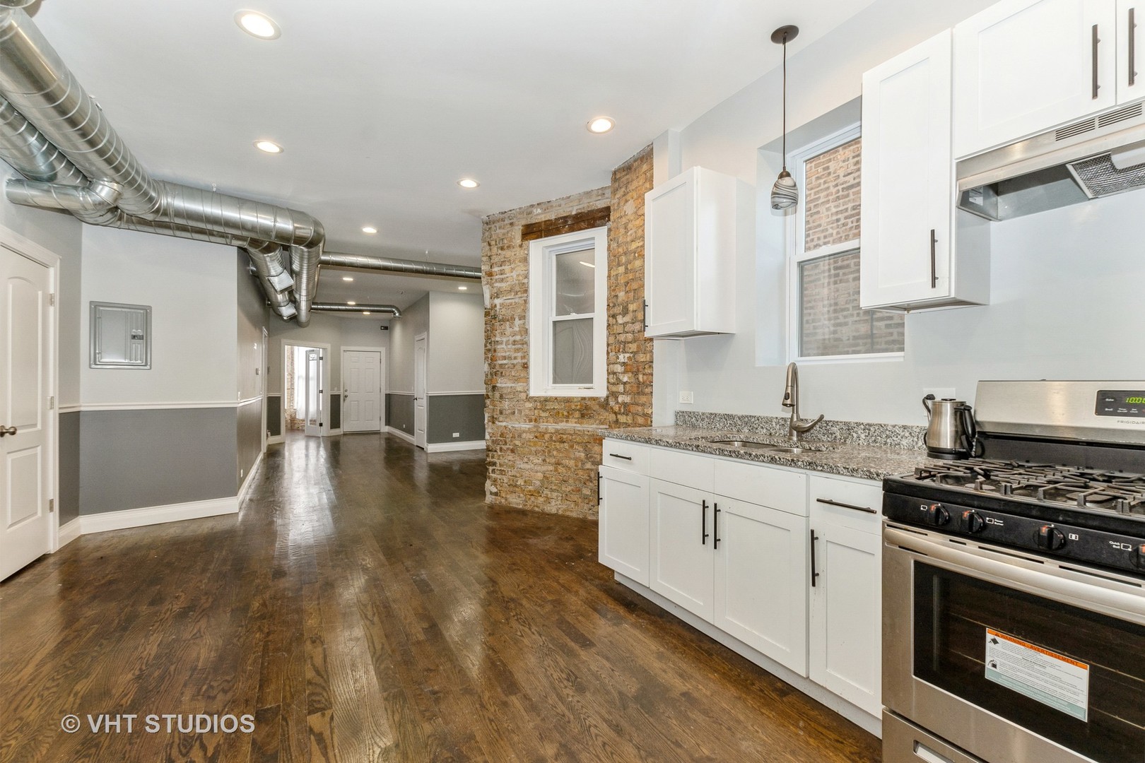 Undisclosed Address Chicago, IL 60637 - Photo 12 of 12 a kitchen with granite countertop a stove and white cabinets