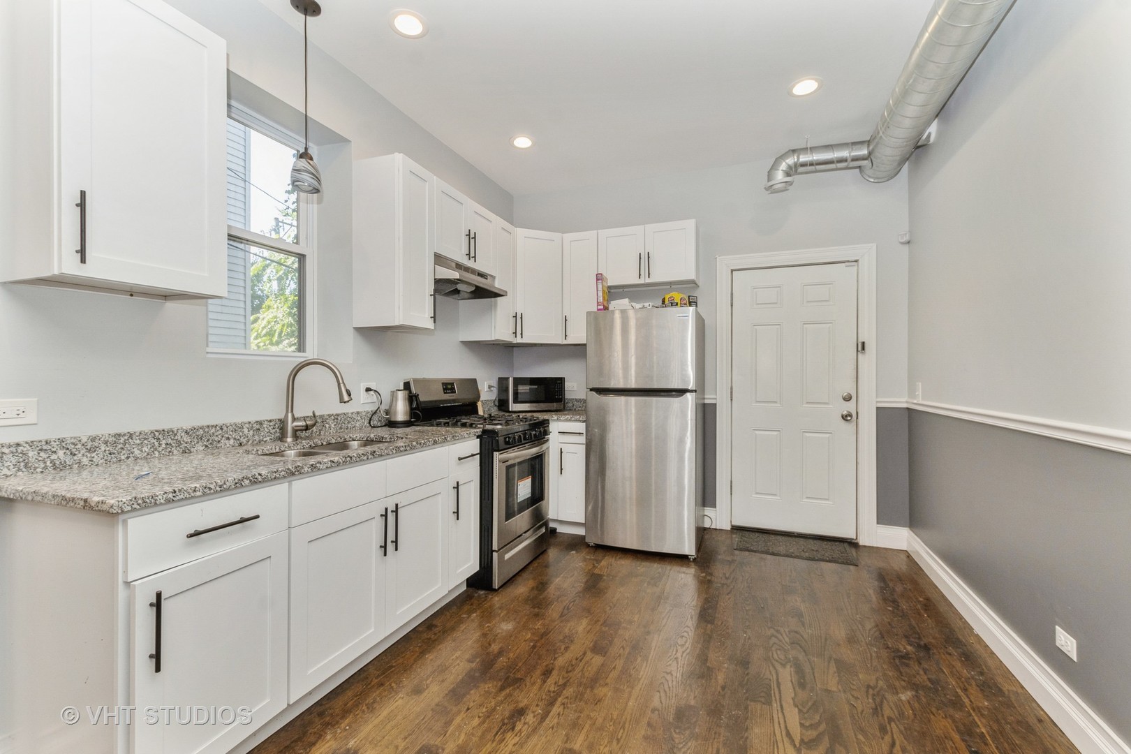 Undisclosed Address Chicago, IL 60637 - Photo 10 of 12 a kitchen with white cabinets and stainless steel appliances
