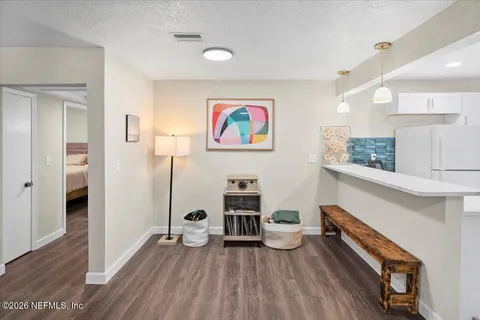 a view of an entryway with wooden floor
