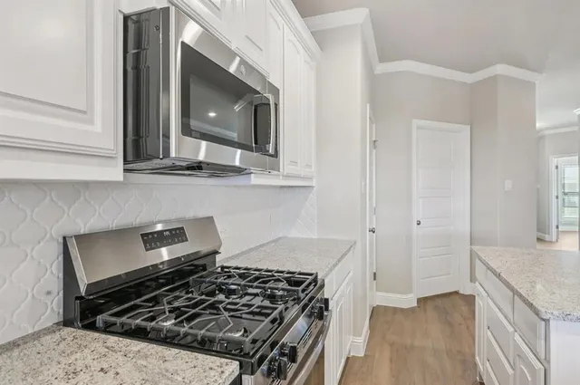 a kitchen with granite countertop a stove and a sink