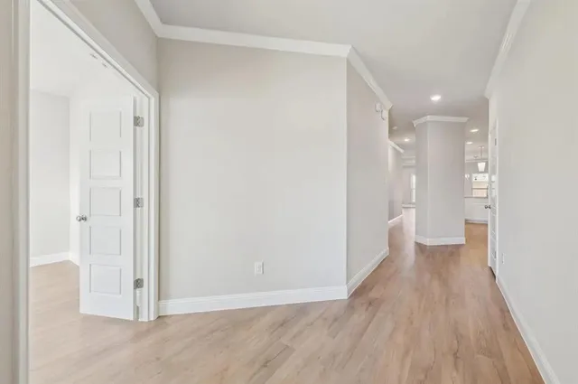 a view of a hallway with wooden floor