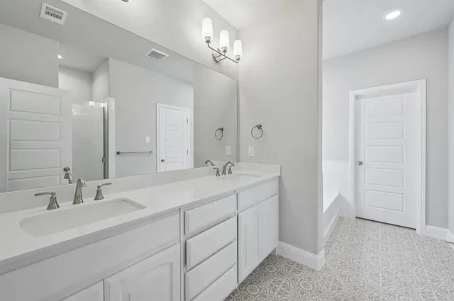 a bathroom with a double vanity sink and a mirror