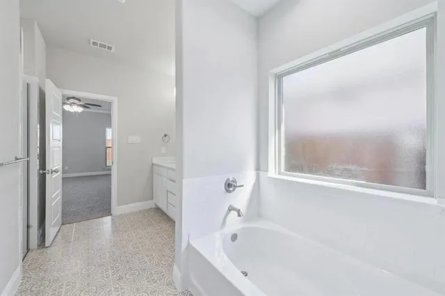 a white bath tub sitting next to a shower