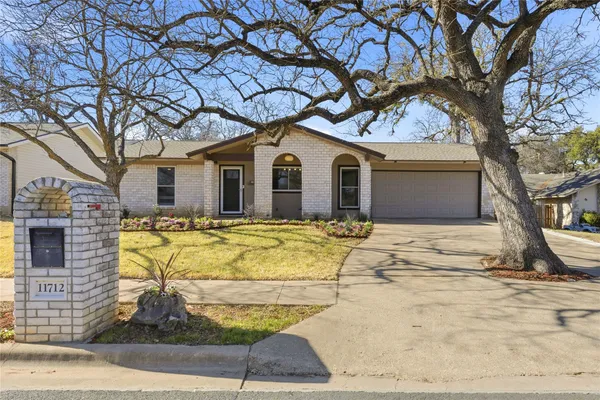 a house that has a tree in front of it