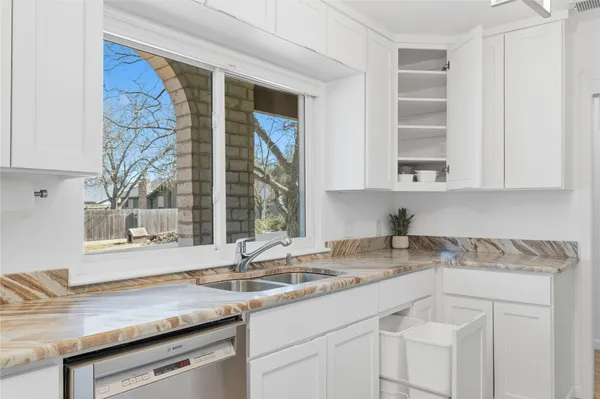 a kitchen with a sink cabinets and window