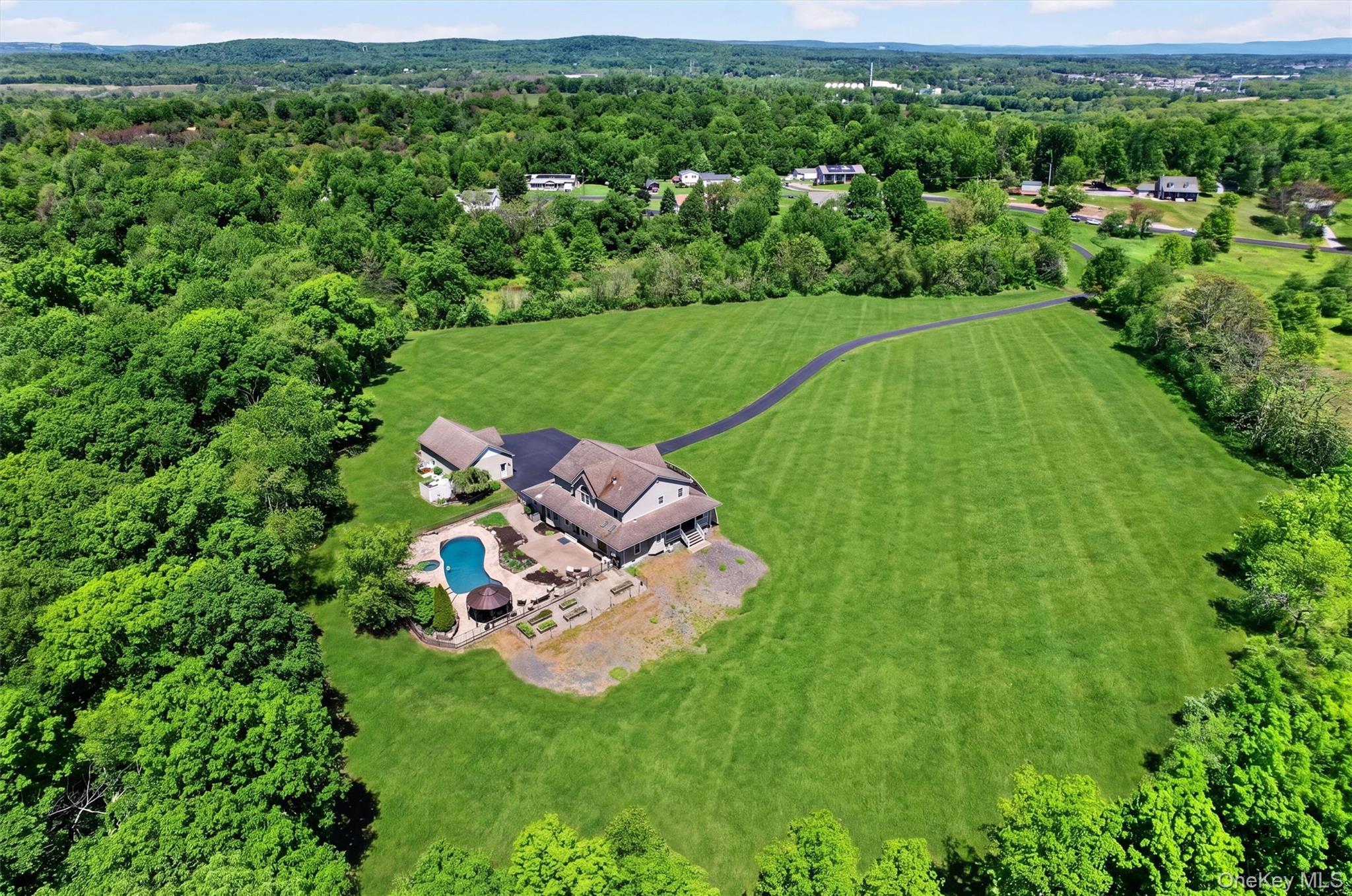 954 Ridgebury Road New Hampton, NY 10958 - Photo 45 of 45 A sweeping aerial view shows the home surrounded by open lawn, mature trees, and rolling scenery, offering a wonderful sense of privacy and space. The mowed area reflects roughly 5 acres of the entire 44+ acre parcel!