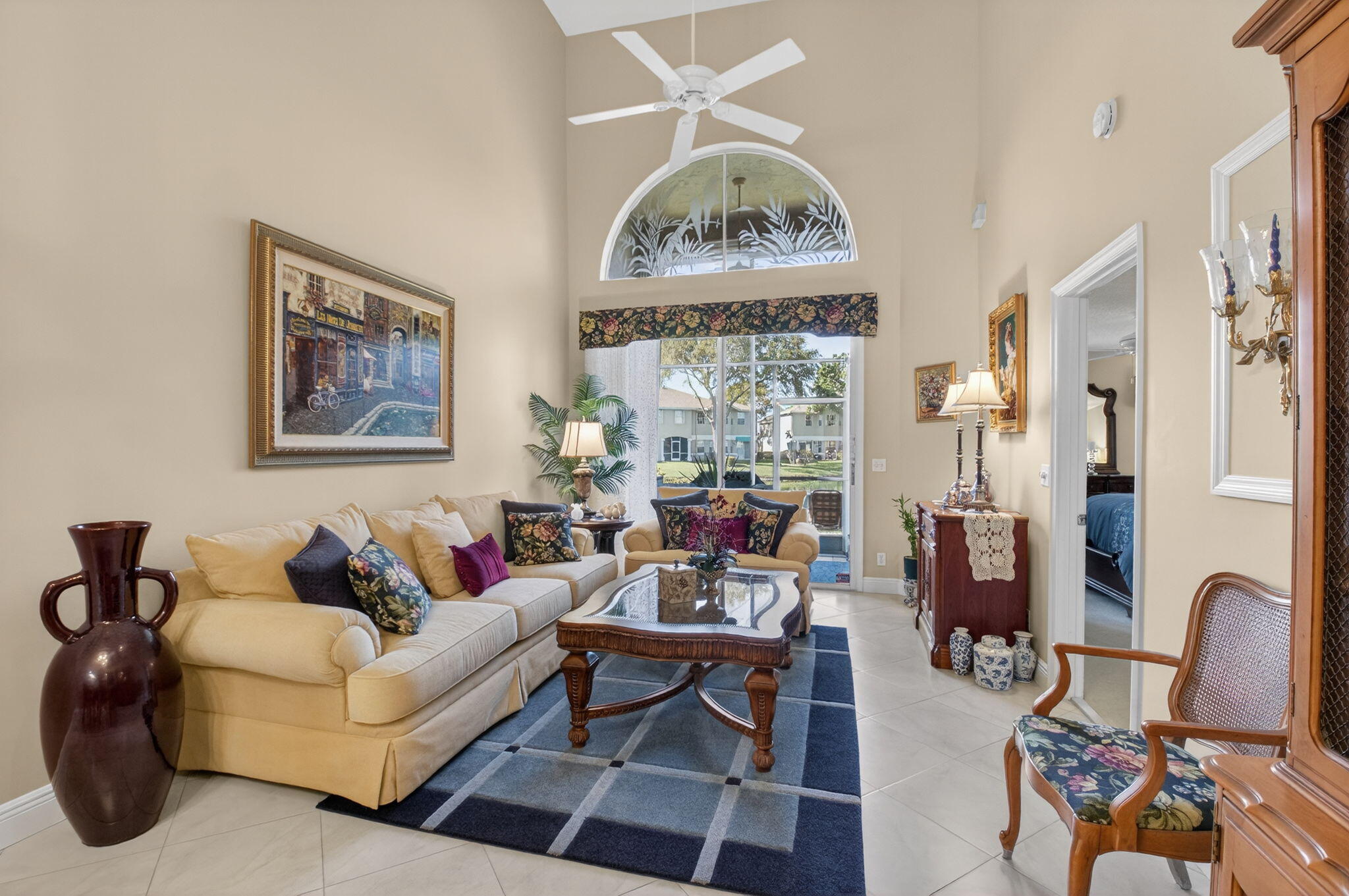 9064 Boca Gardens Parkway, Unit B Boca Raton, FL 33496 - Photo 15 of 41 a living room with furniture a rug a table and a large window
