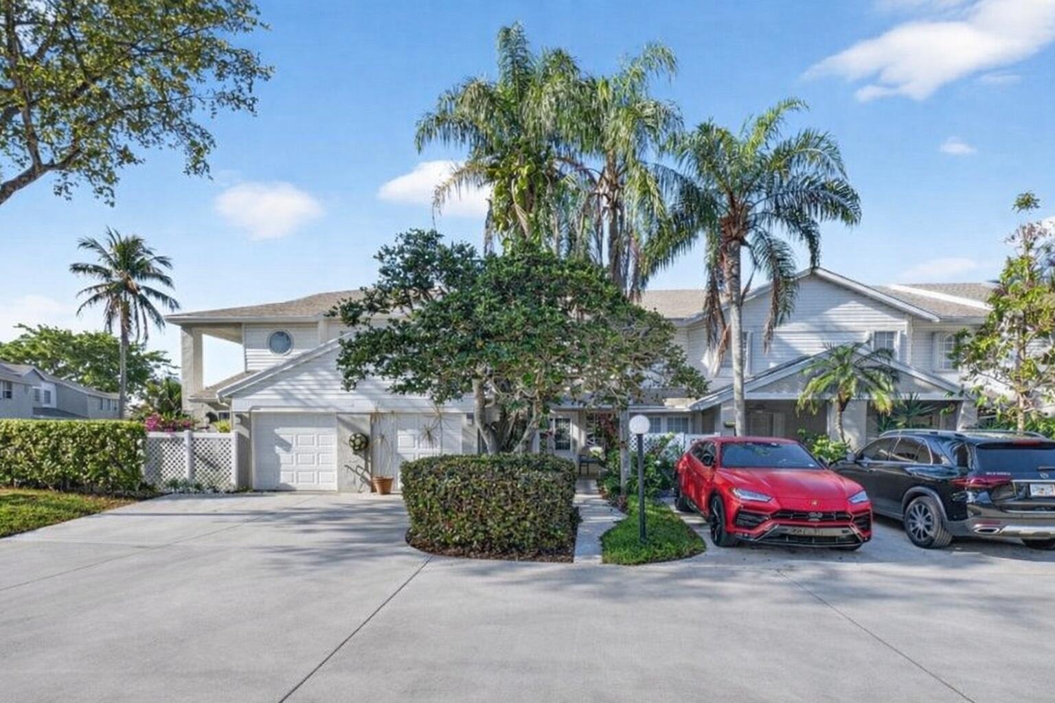 9064 Boca Gardens Parkway, Unit B Boca Raton, FL 33496 - Photo 2 of 41 a car parked in front of a house