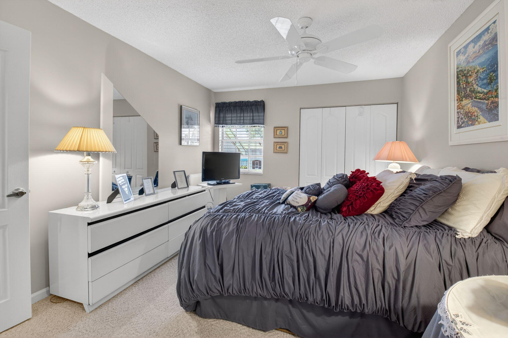 9064 Boca Gardens Parkway, Unit B Boca Raton, FL 33496 - Photo 29 of 41 a bedroom with a bed and a chandelier