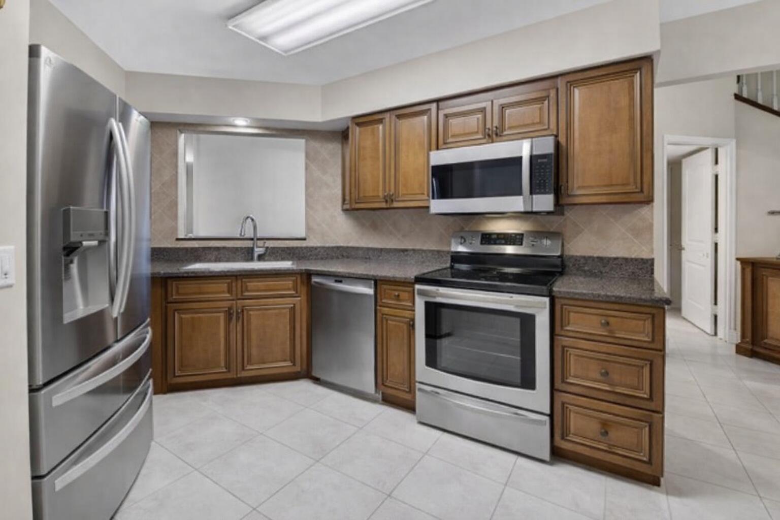 9064 Boca Gardens Parkway, Unit B Boca Raton, FL 33496 - Photo 5 of 41 Modern U-shaped kitchen with stainless s