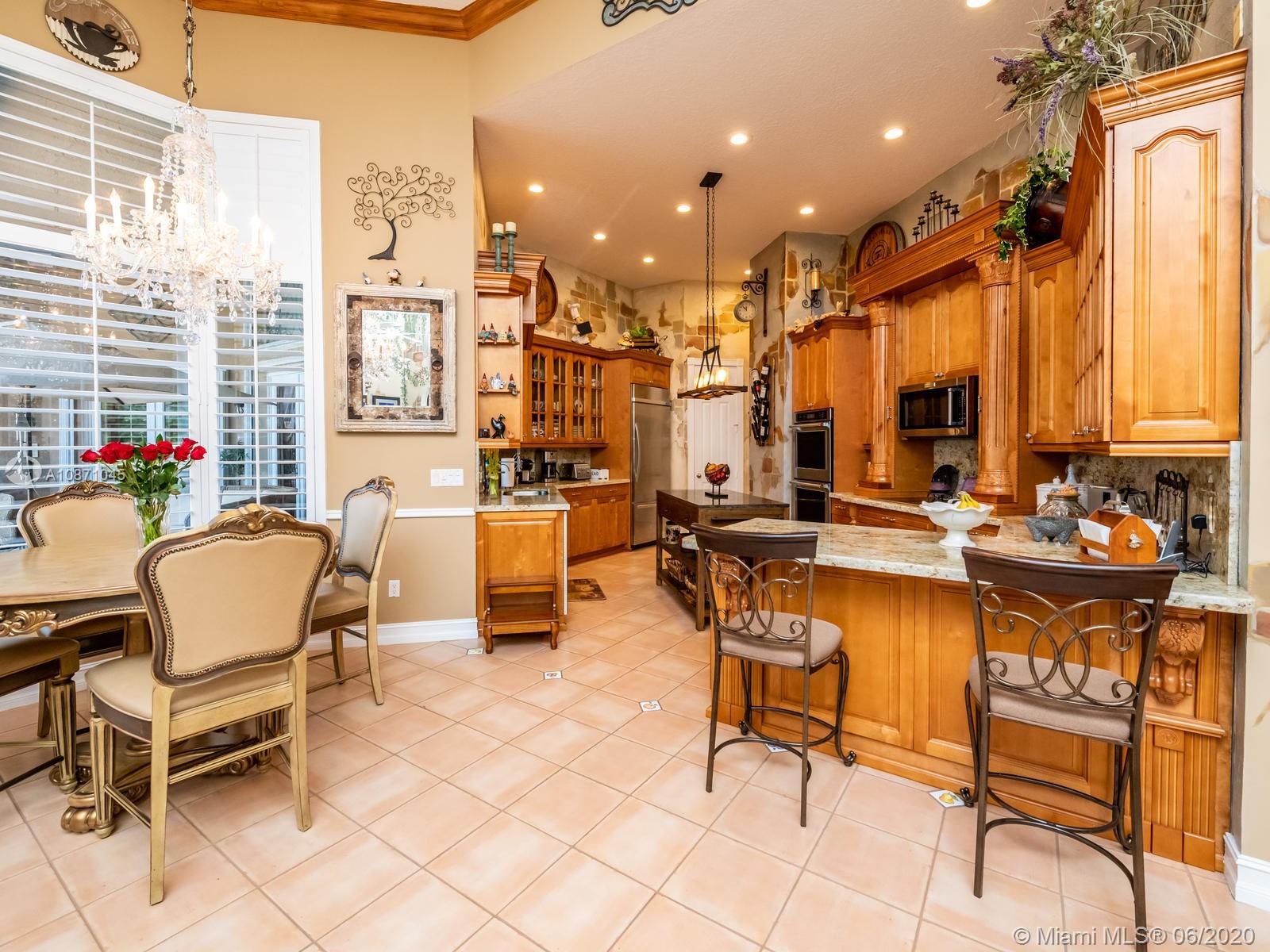 21663 Fall River Drive Boca Raton, FL 33428 - Photo 11 of 48 a view of a patio with dining table and chairs