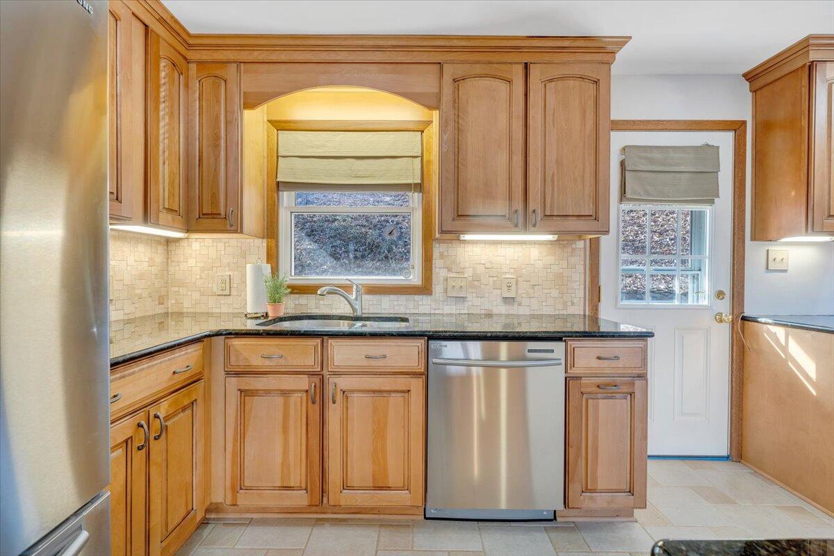 4151 Givens Road Salem, VA 24153 - Photo 15 of 45 a kitchen with granite countertop a sink stainless steel appliances and cabinets