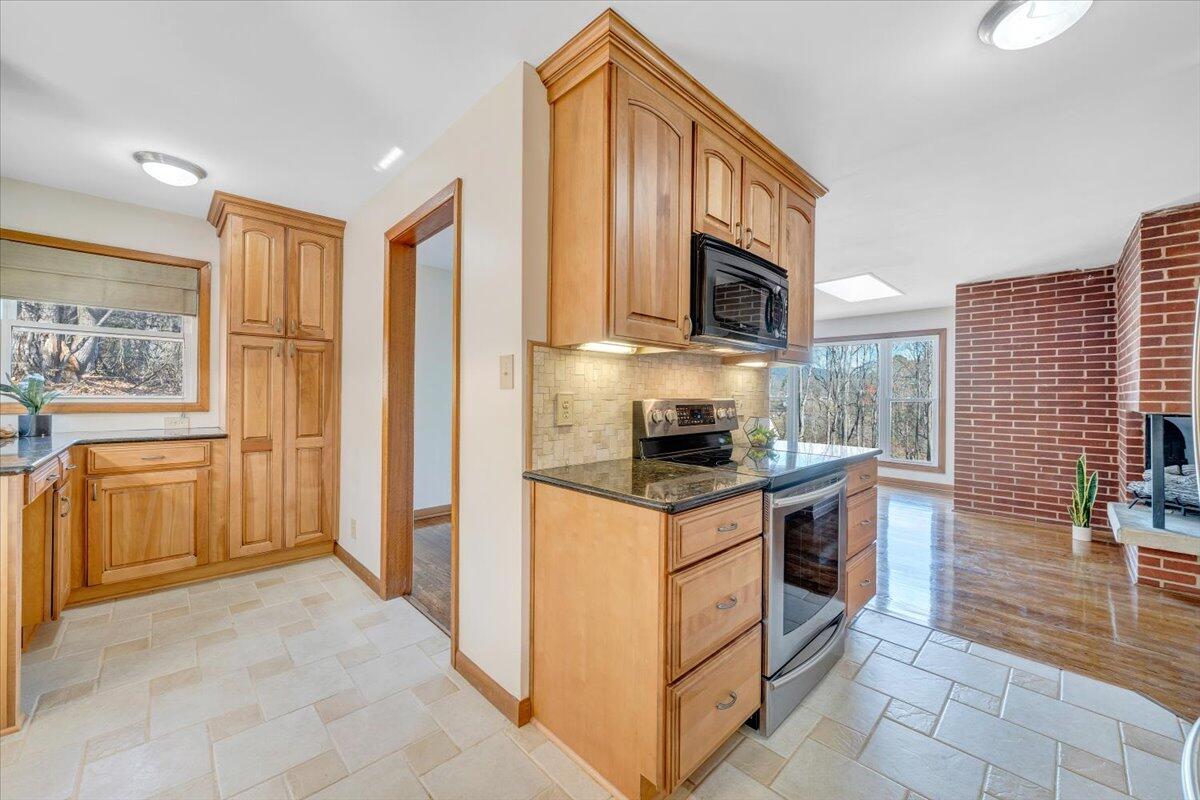 4151 Givens Road Salem, VA 24153 - Photo 18 of 45 a kitchen with stainless steel appliances granite countertop a stove a sink and a refrigerator