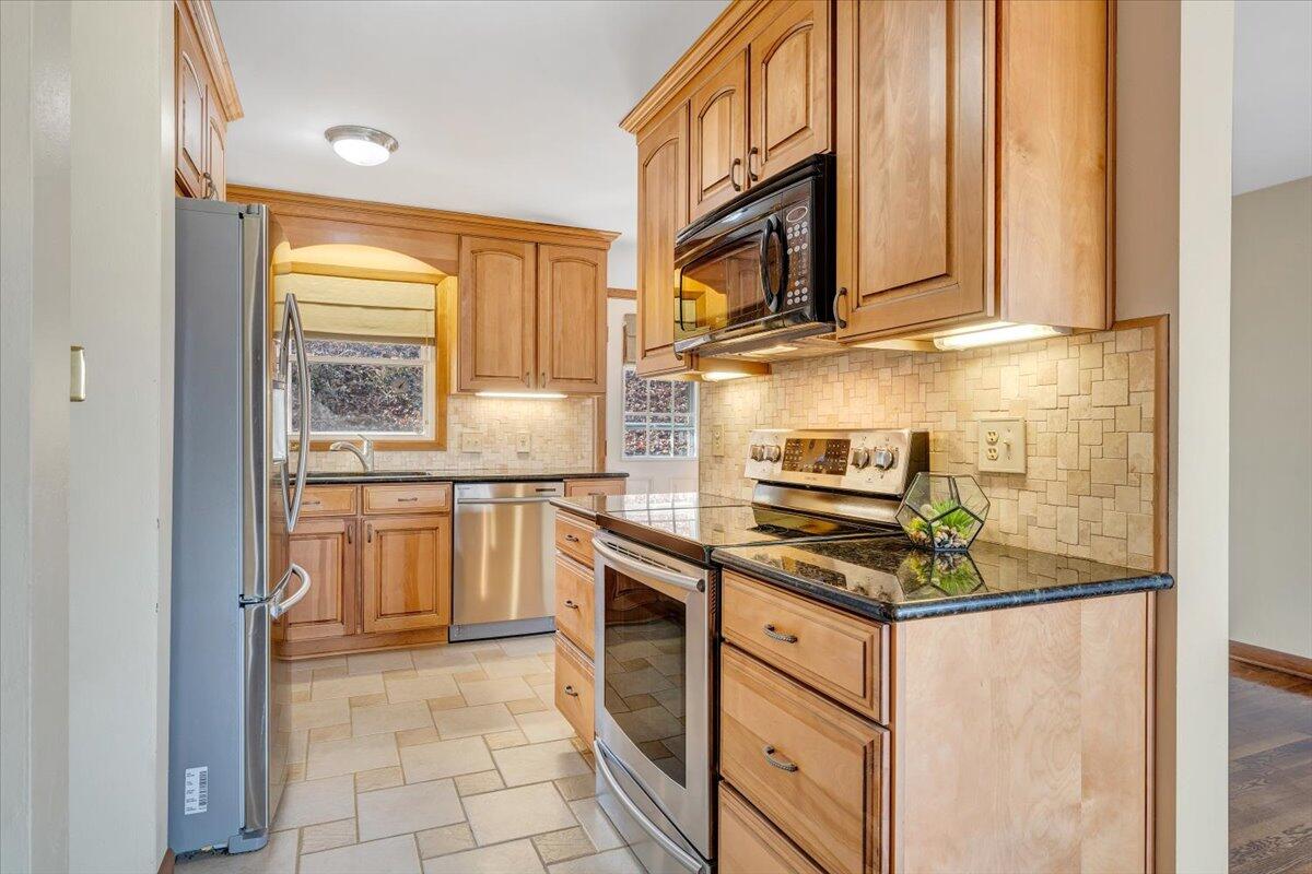 4151 Givens Road Salem, VA 24153 - Photo 19 of 45 a kitchen with stainless steel appliances granite countertop a stove a sink and a microwave