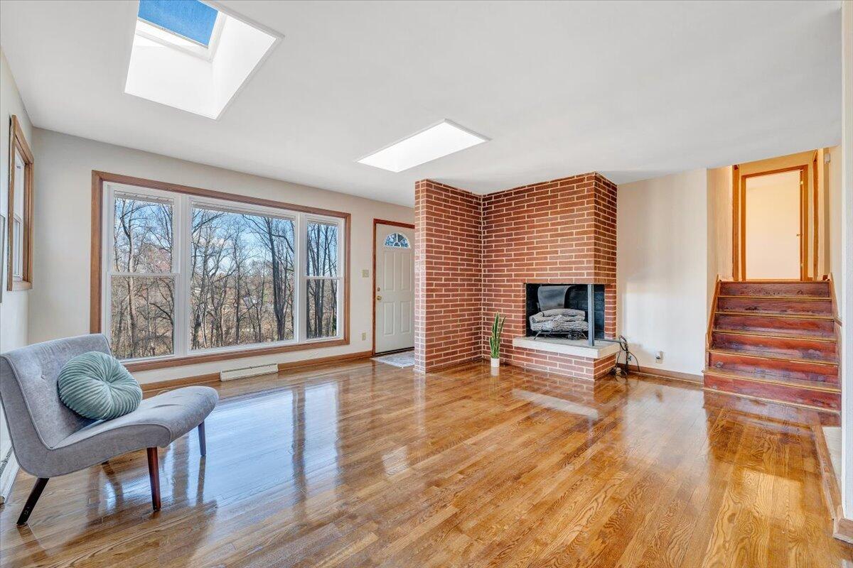 4151 Givens Road Salem, VA 24153 - Photo 8 of 45 a view of a livingroom with furniture a fireplace and wooden floor