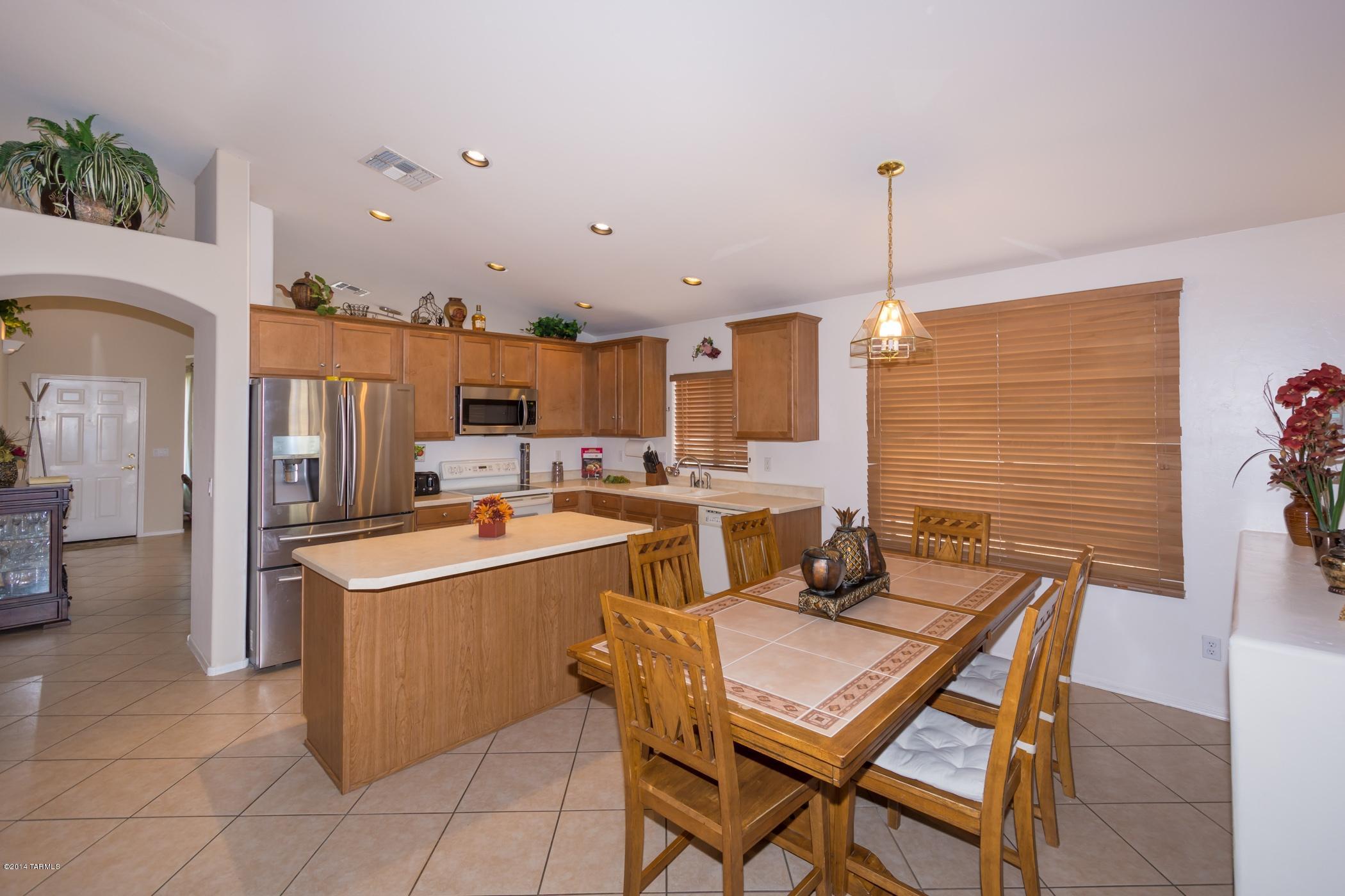 4648 South Valley Road Tucson, AZ 85714 - Photo 7 of 30 a kitchen with a sink a counter top space and stainless steel appliances