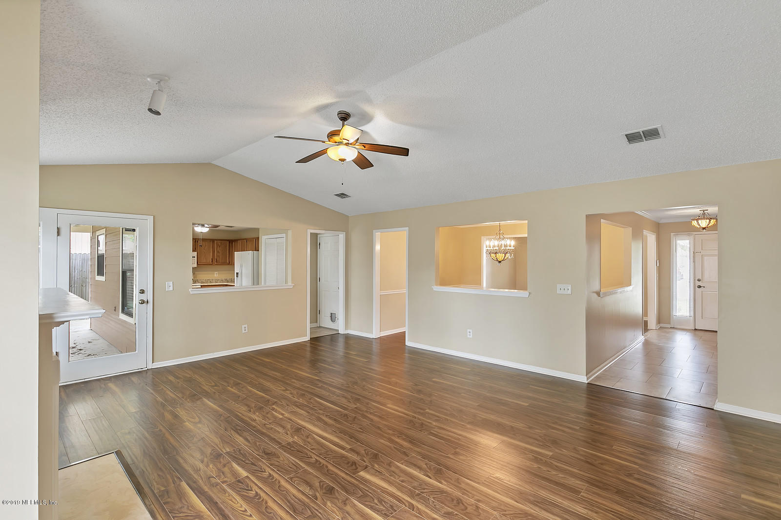 12436 Running River Road South Jacksonville, FL 32225 - Photo 5 of 25 a view of an empty room with wooden floor and a window