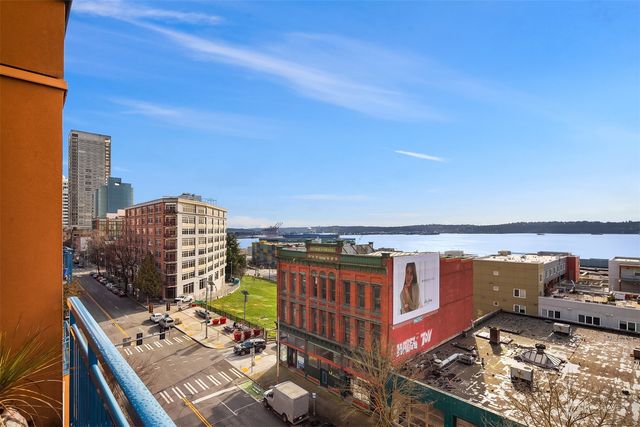 a living room with furniture large window and glass table