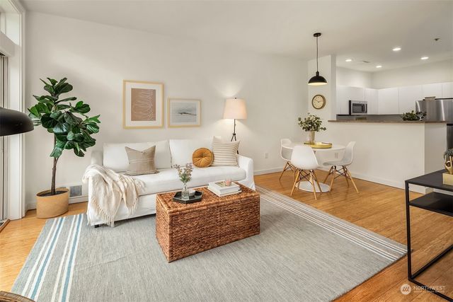 a living room with fireplace furniture and a potted plant