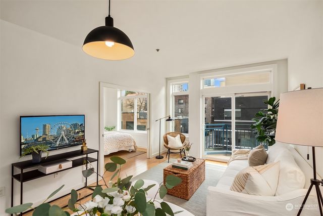 a view of a balcony with two chairs and a potted plant
