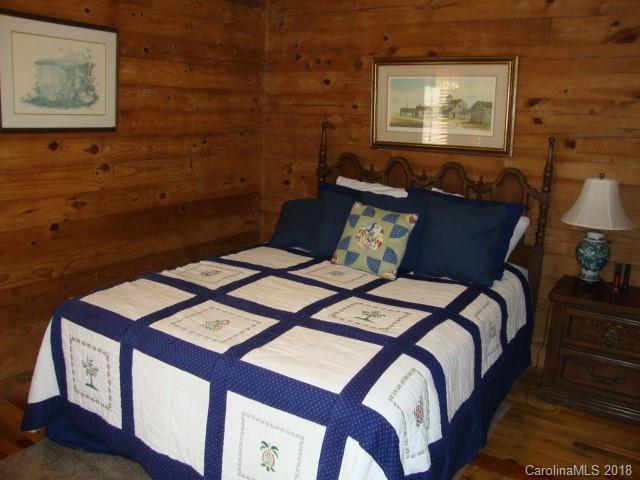 249 Nottingham Road, Unit 10 Maggie Valley, NC 28751 - Photo 11 of 24 a bedroom with a bed and a lamp on dresser
