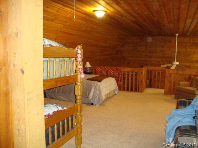 249 Nottingham Road, Unit 10 Maggie Valley, NC 28751 - Photo 15 of 24 a bedroom with a bed and wooden floor