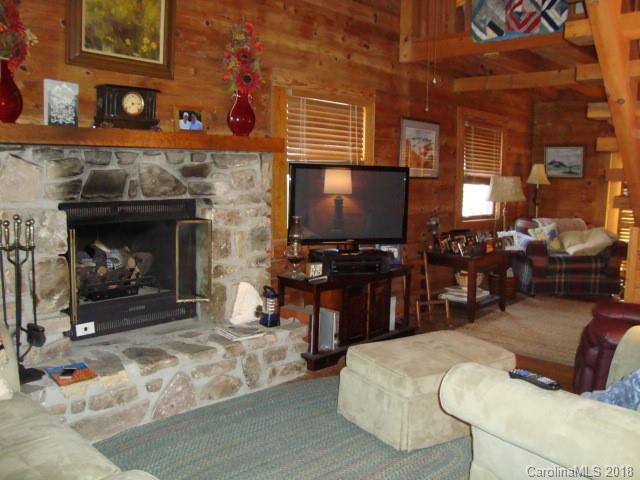 249 Nottingham Road, Unit 10 Maggie Valley, NC 28751 - Photo 4 of 24 a living room with furniture and a fireplace