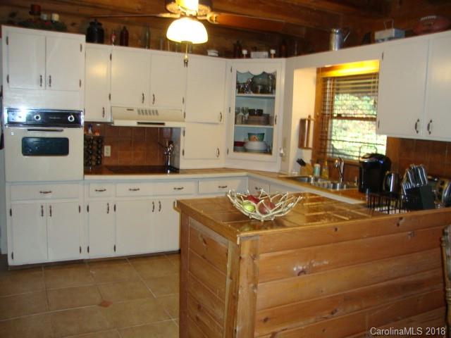 249 Nottingham Road, Unit 10 Maggie Valley, NC 28751 - Photo 8 of 24 a kitchen with stainless steel appliances kitchen island granite countertop a sink stove and cabinets