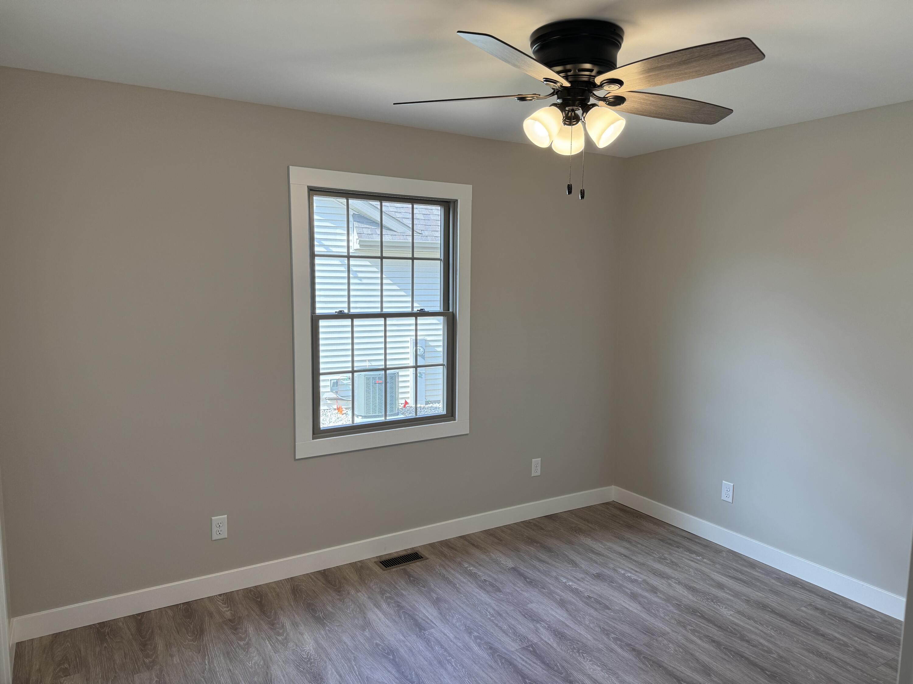 821 9th Street Southwest, Unit 10B De Motte, IN 46310 - Photo 13 of 17 a view of an empty room with a window and wooden floor