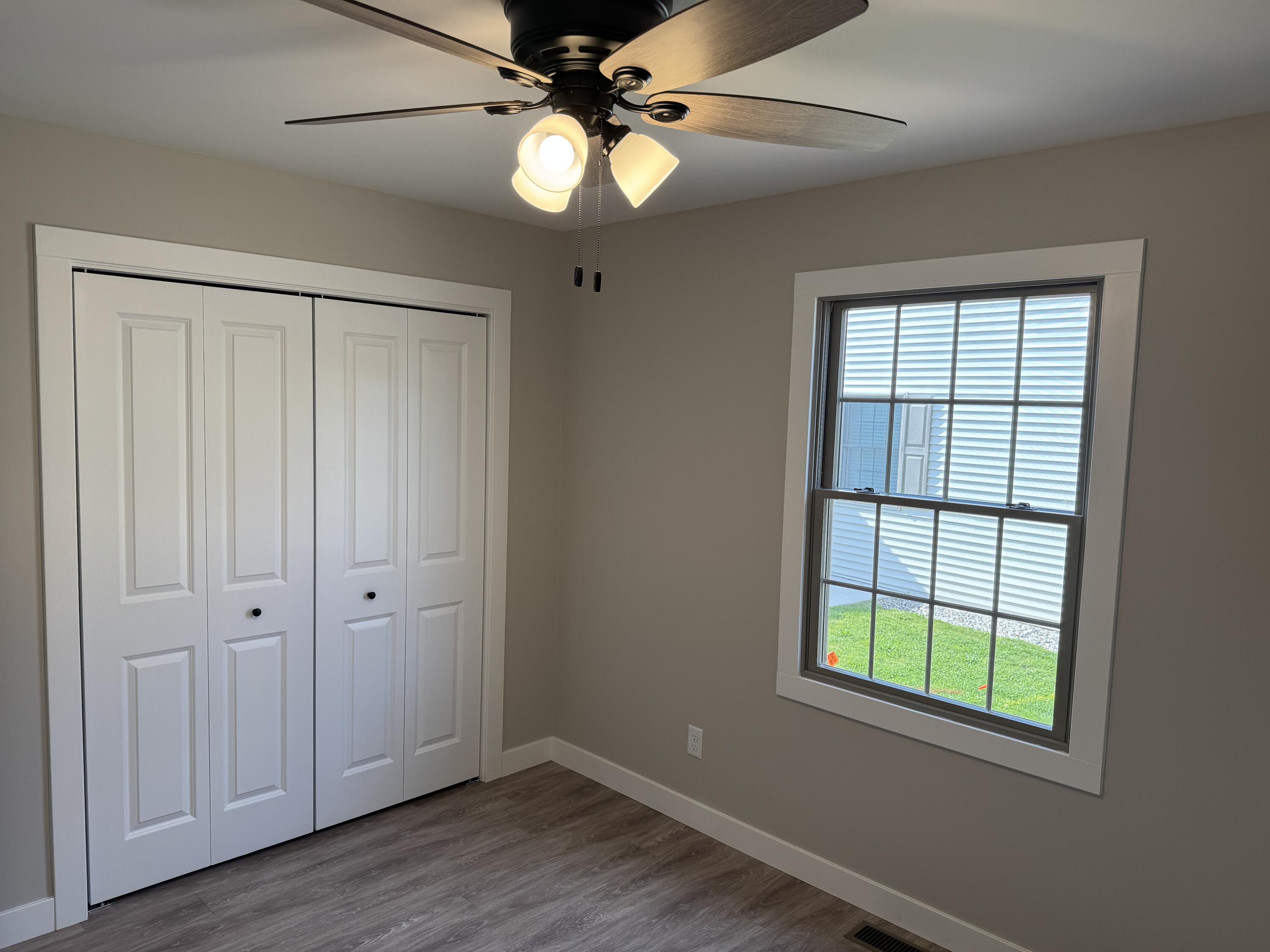 821 9th Street Southwest, Unit 10B De Motte, IN 46310 - Photo 14 of 17 an empty room with wooden floor fan and windows