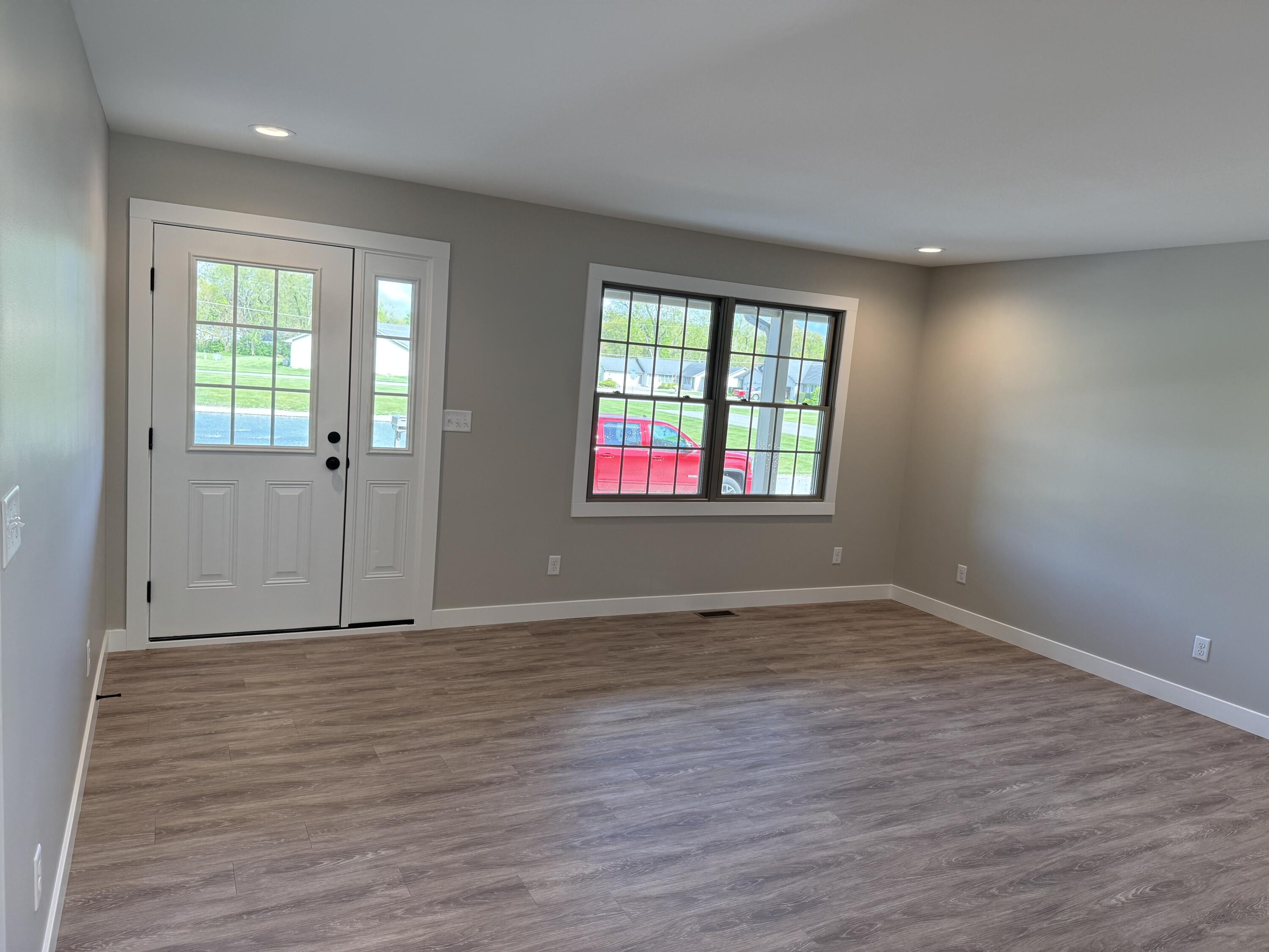 821 9th Street Southwest, Unit 10B De Motte, IN 46310 - Photo 4 of 17 a view of an empty room with wooden floor and a window