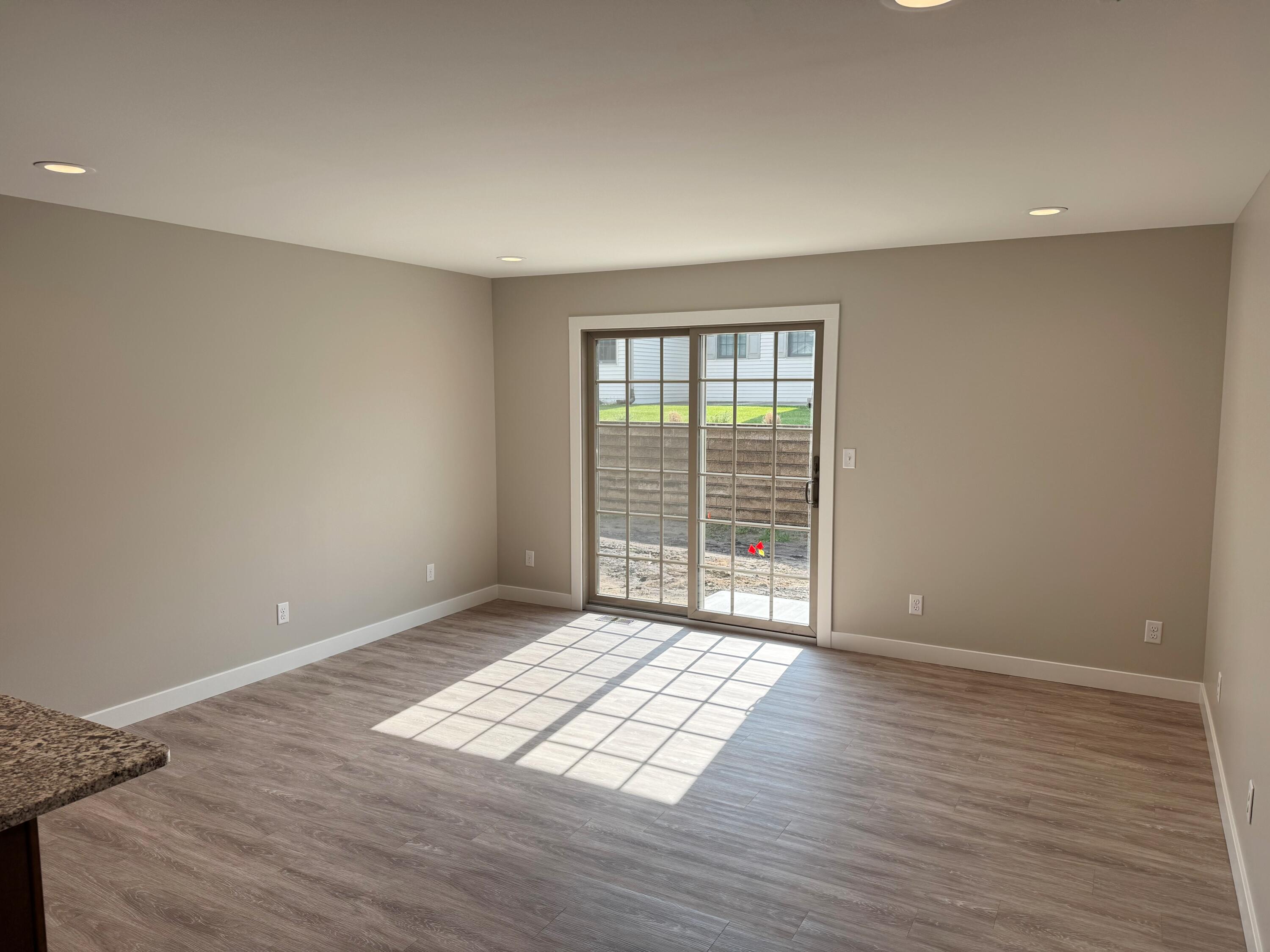 821 9th Street Southwest, Unit 10B De Motte, IN 46310 - Photo 8 of 17 a view of an empty room with wooden floor and a window