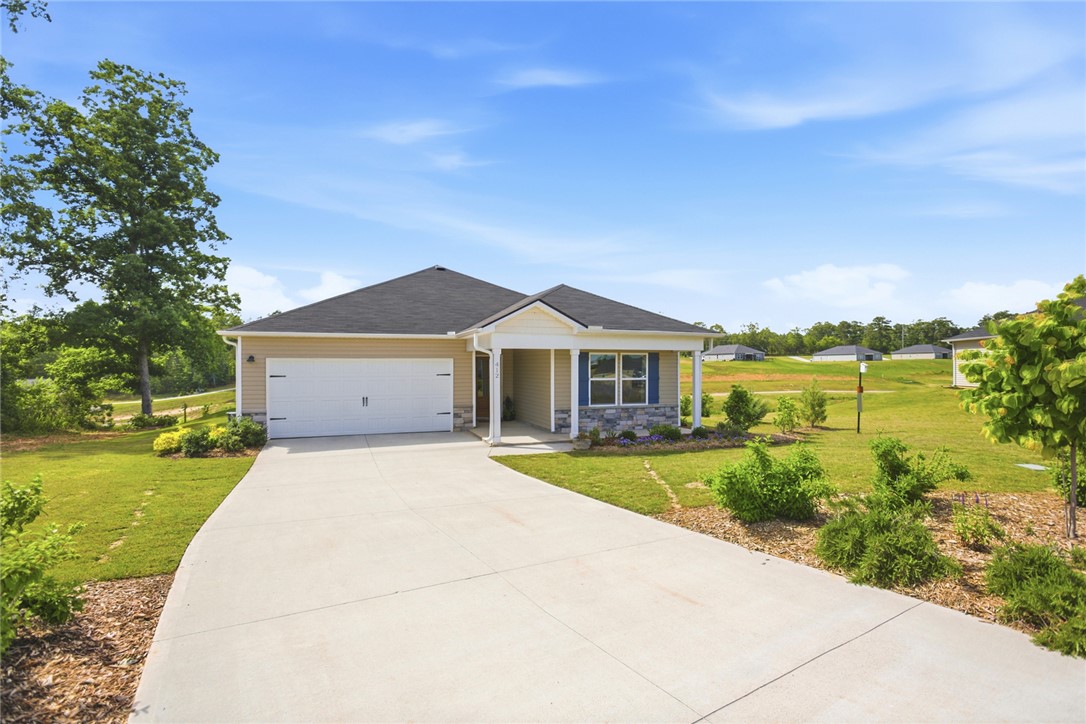 412 Chadwick Lane Walhalla, SC 29691 - Photo 3 of 37 This appealing single-story home showcases a welcoming front porch and a wide concrete driveway leading to the garage.