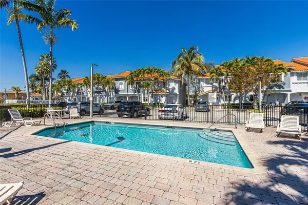 a view of swimming pool with outdoor seating and a patio