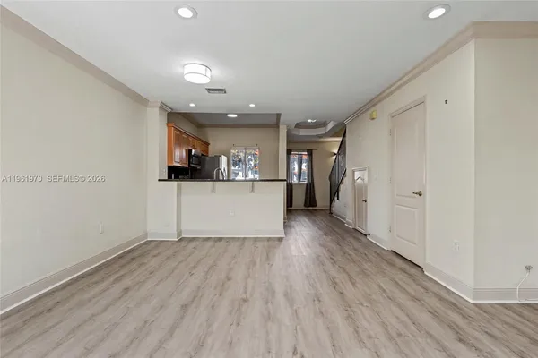 a view of staircase with railing and white walls