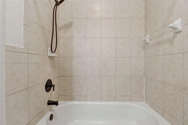 a bedroom with a bed and a potted plant