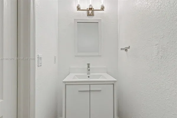 a utility room with cabinets washer and dryer
