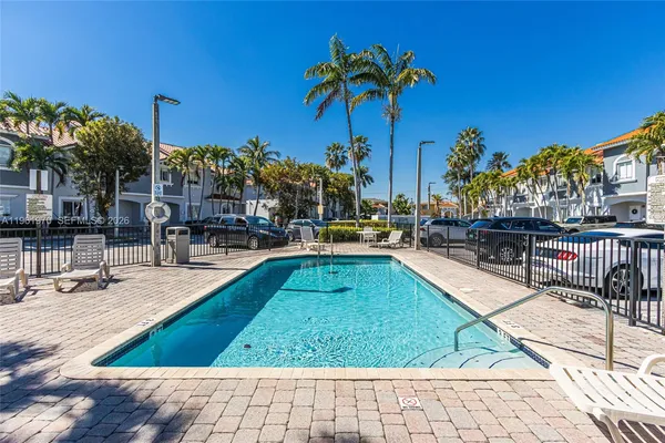 a swimming pool with outdoor seating and yard