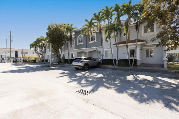 a front view of a house with plants