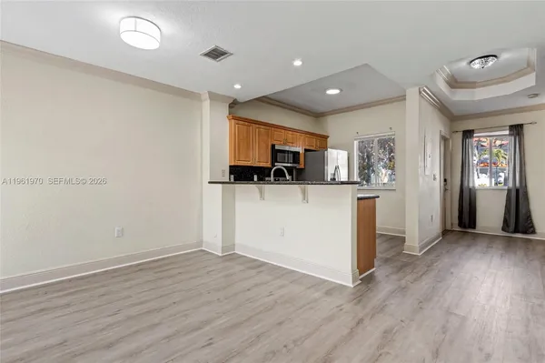 a view of a hallway with wooden floor