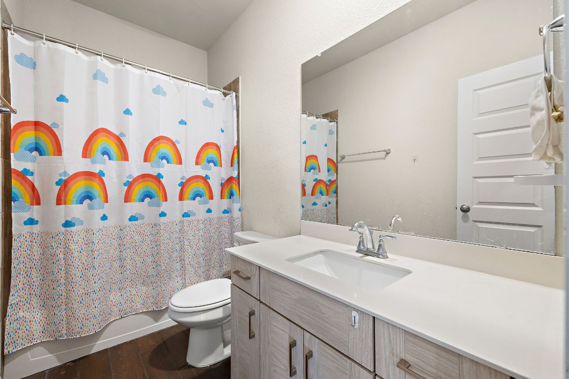 120 Upland Drive Georgetown, TX 78628 - Photo 15 of 21 Bathroom with vanity, dark wood-type flooring, and a shower with curtain