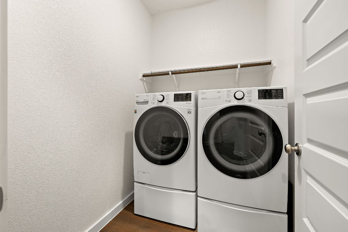 120 Upland Drive Georgetown, TX 78628 - Photo 18 of 21 Laundry room featuring independent washer and dryer, a textured wall, and dark wood finished floors