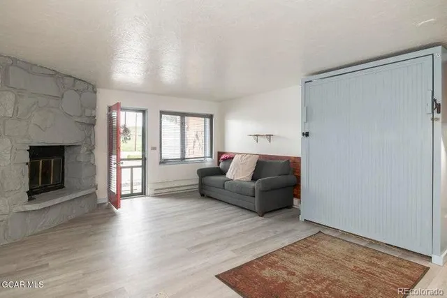 a living room with furniture and a fireplace