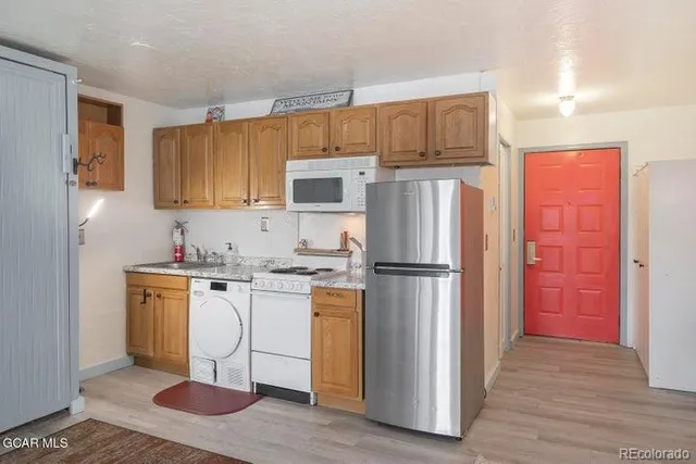 a kitchen with stainless steel appliances a refrigerator stove and sink