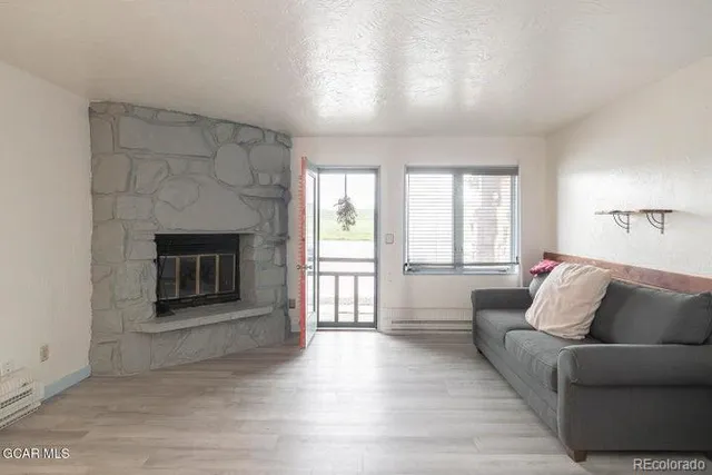 a living room with furniture and a fireplace