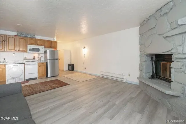 a view of a kitchen with a stove cabinets and a wooden floor