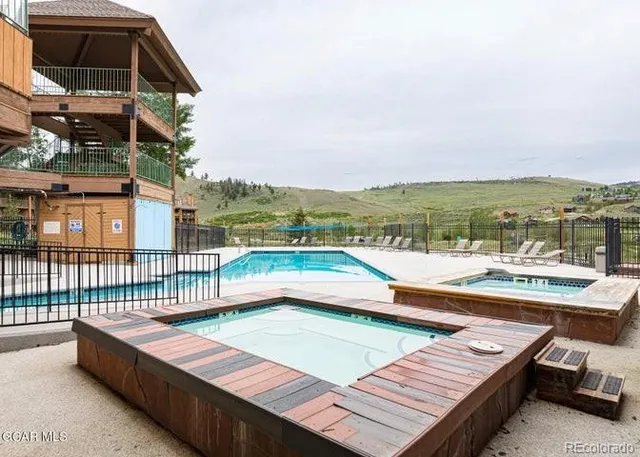 a view of a balcony with two chairs and a potted plant