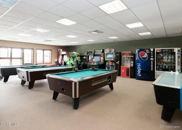 a living room with furniture and pool table