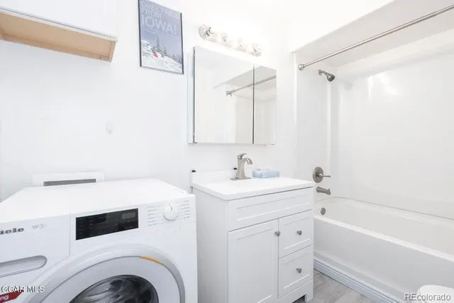 a view of bathroom with a sink a washer and dryer