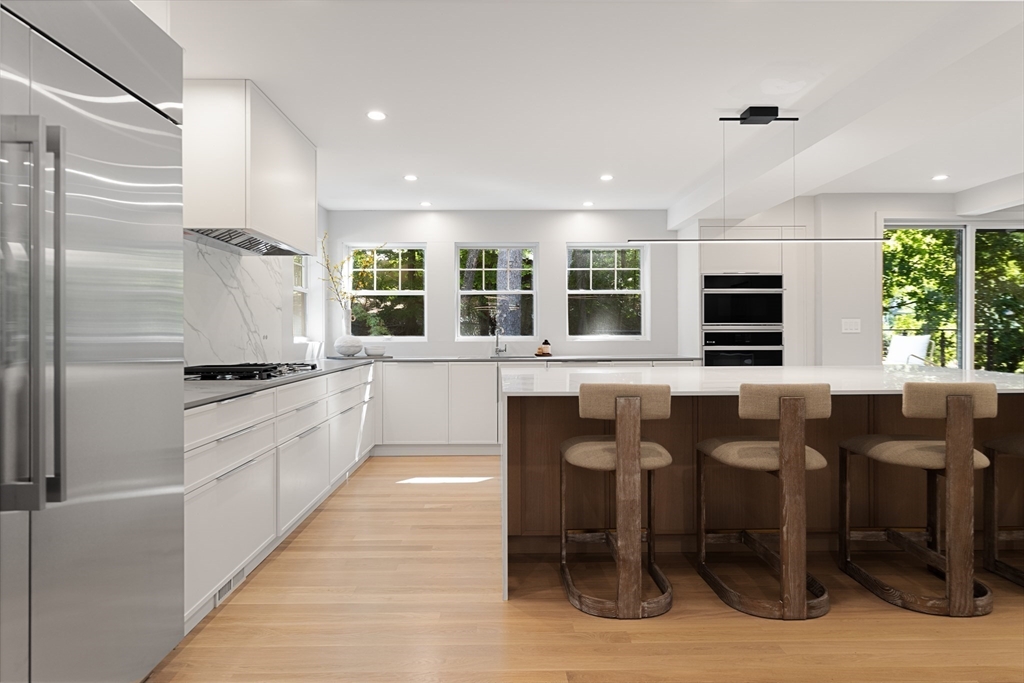 100 Varick Road Newton, MA 02468 - Photo 6 of 20 a large white kitchen with granite countertop lots of counter top and stainless steel appliances